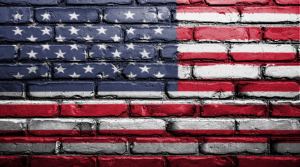 Photo of American flag painted on a brick wall